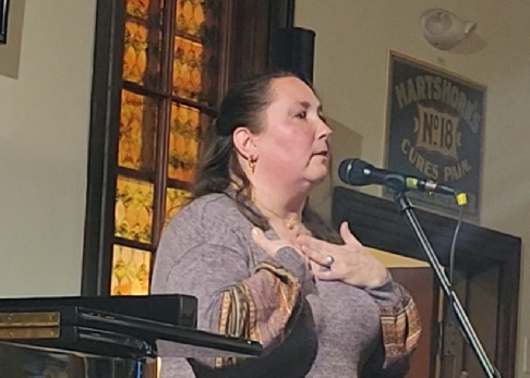 An image of Esther Rhatigan singing at 19 Carter in Berlin, MA.
